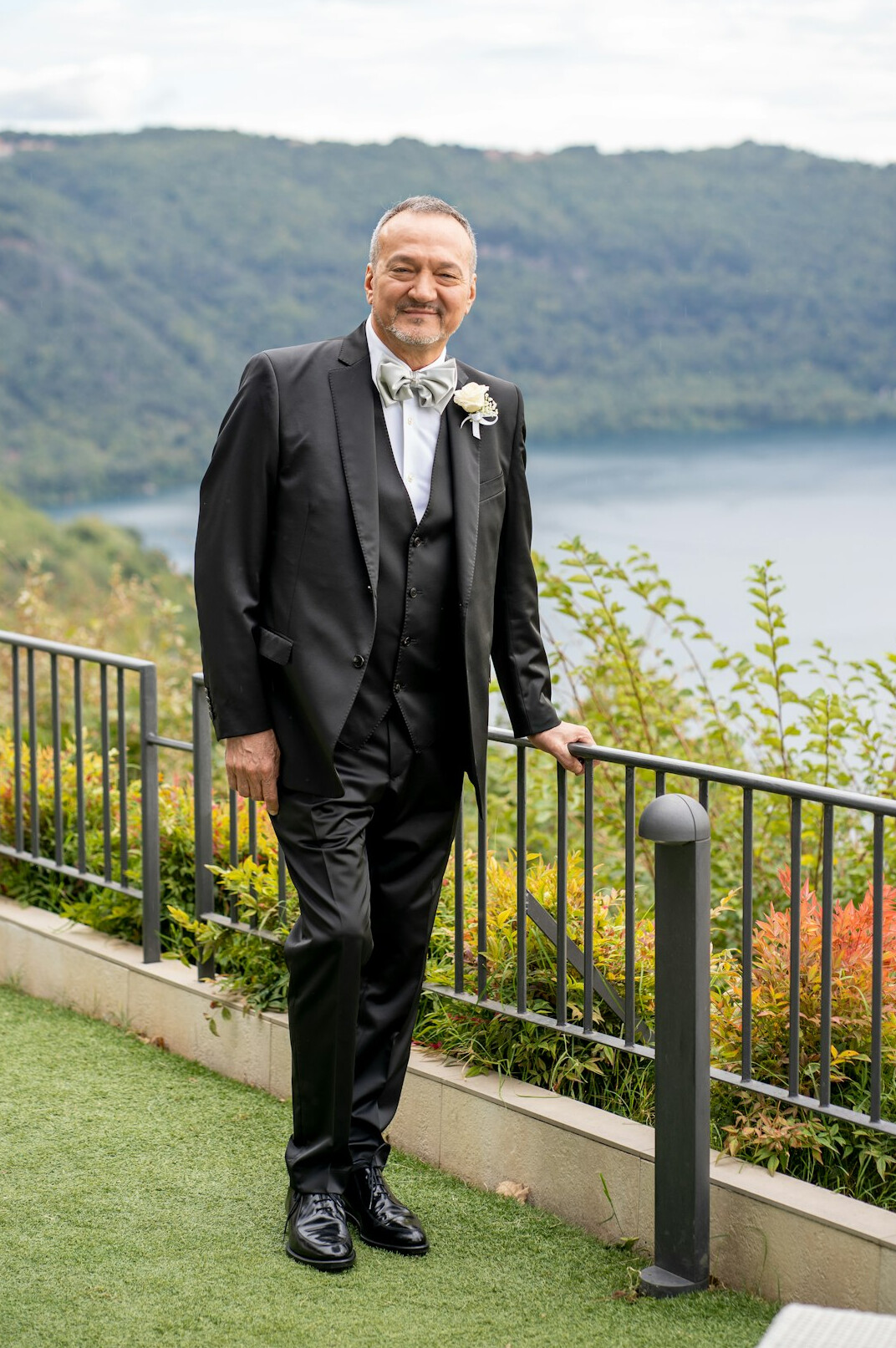 Portrait of a man in a dark suit smiling at the camera